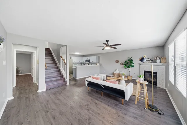 a living room with furniture and wooden floor