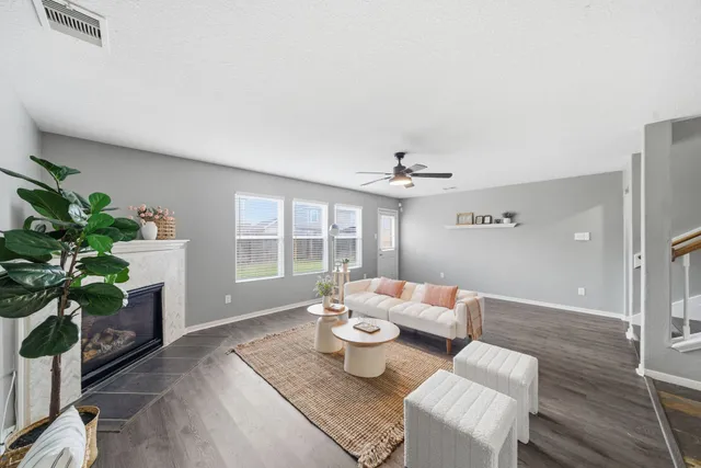 a living room with furniture and a potted plant