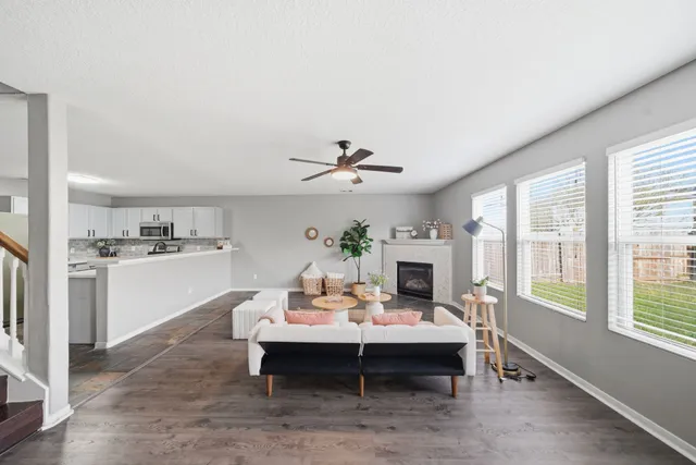 a living room with furniture fireplace and window
