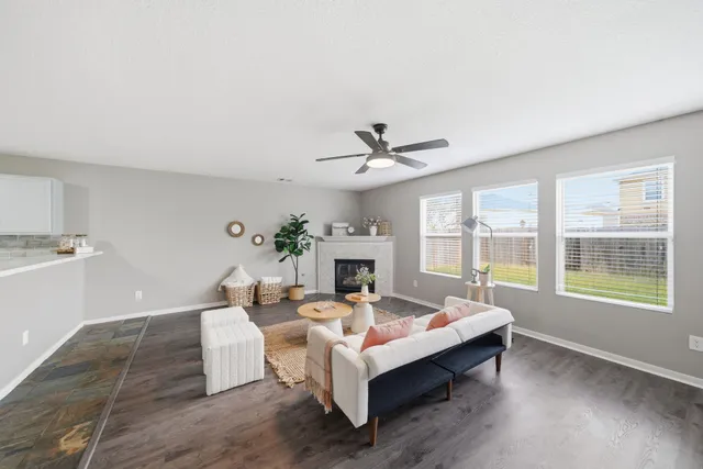a living room with furniture large window and a fireplace