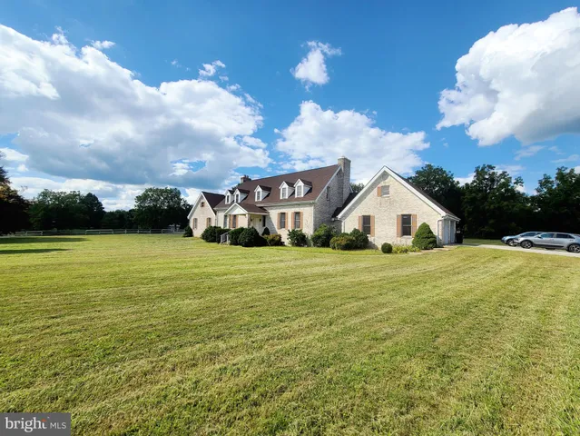 a front view of house with yard and green space