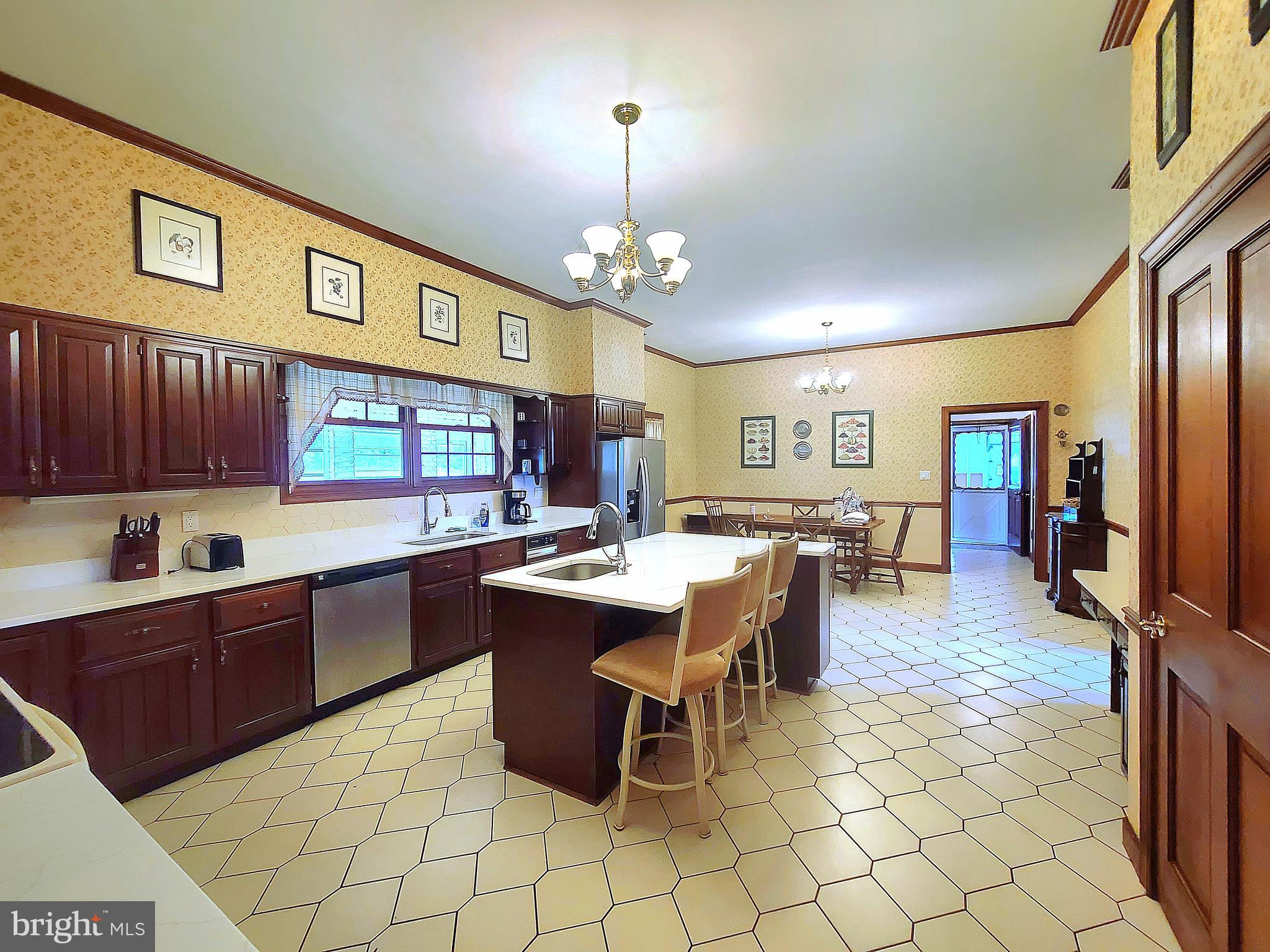13212 Beaver Dam Road Cockeysville, MD 21030 - Photo 12 of 55 a kitchen with stainless steel appliances granite countertop a sink dishwasher a dining table and chairs with wooden floor