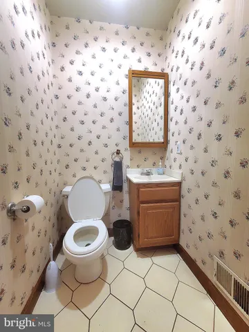 a living room with furniture a window and wooden floor