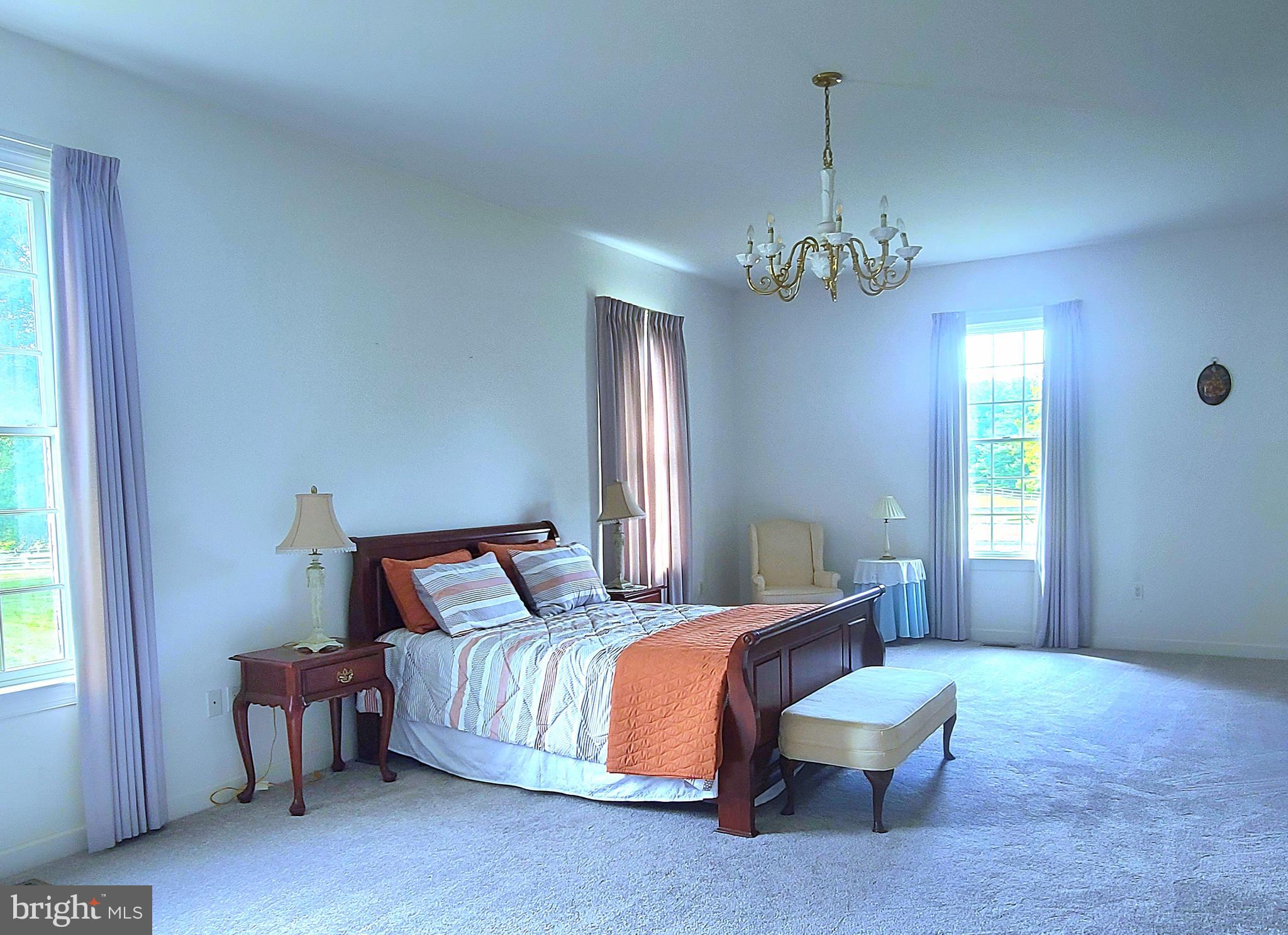 13212 Beaver Dam Road Cockeysville, MD 21030 - Photo 26 of 55 a bedroom with a bed and a chandelier