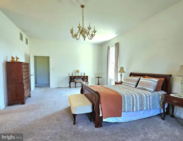 a spacious bedroom with a bed and a couch