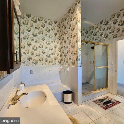 a spacious bathroom with a sink a vanity and a mirror
