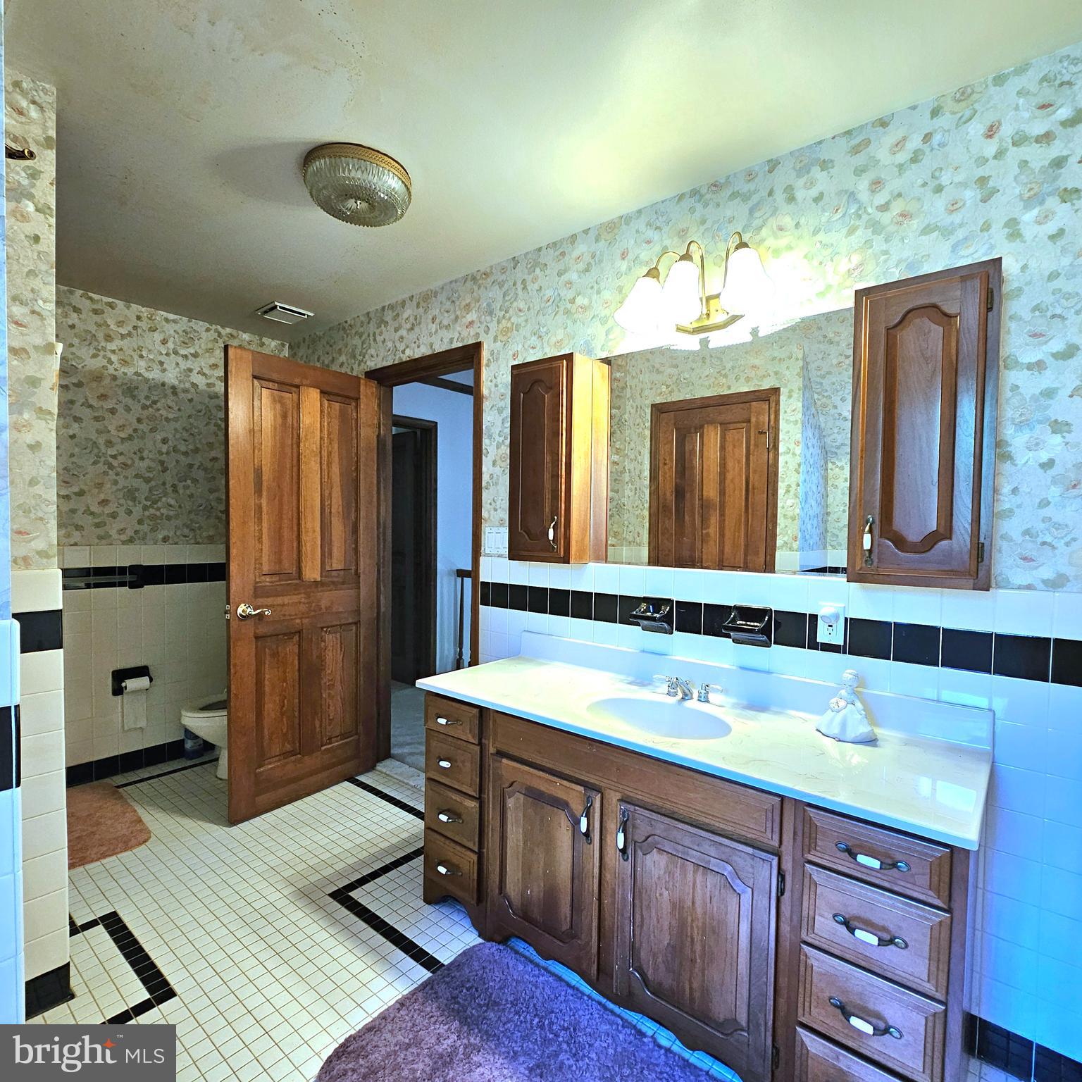 13212 Beaver Dam Road Cockeysville, MD 21030 - Photo 37 of 55 a bathroom with a granite countertop double vanity sink and mirror