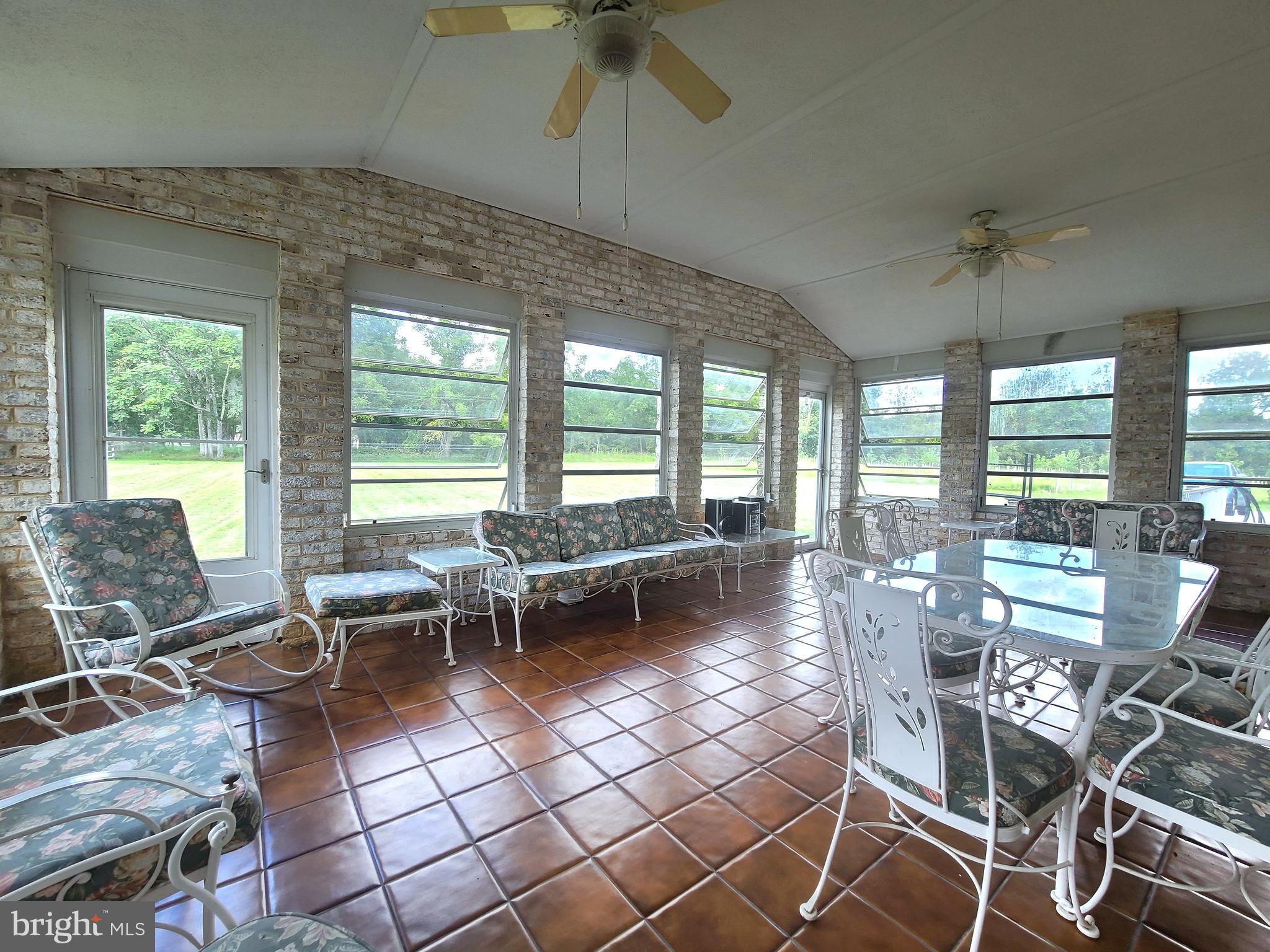 13212 Beaver Dam Road Cockeysville, MD 21030 - Photo 48 of 55 a living room with patio furniture and floor to ceiling windows