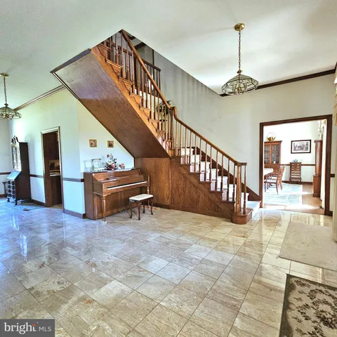 a kitchen with stainless steel appliances granite countertop a sink dishwasher a dining table and chairs with wooden floor