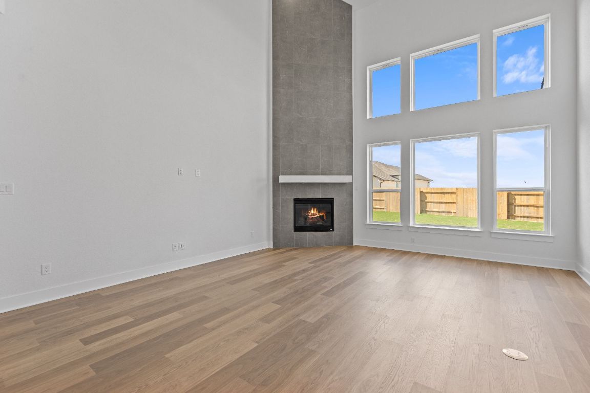 816 South Hemingway Loop Liberty Hill, TX 78642 - Photo 13 of 40 Family Room with soaring ceiling & fireplace