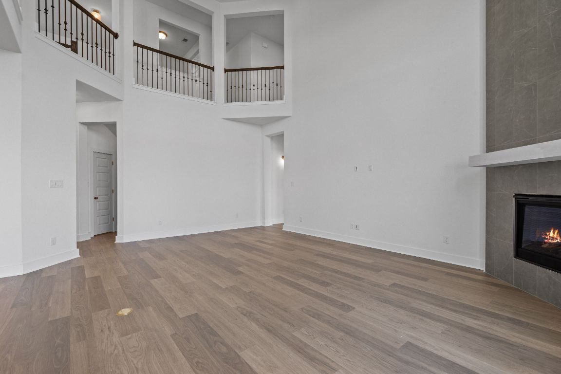 816 South Hemingway Loop Liberty Hill, TX 78642 - Photo 14 of 40 Family Room with soaring ceiling & fireplace