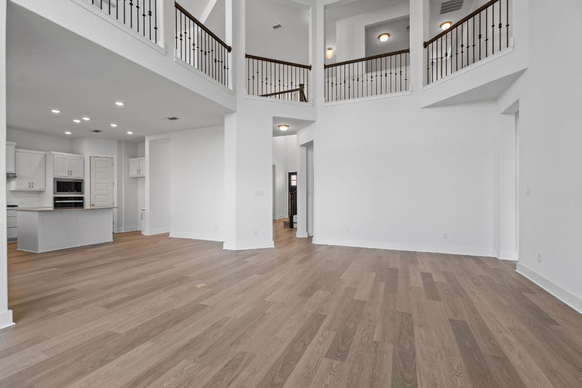 816 South Hemingway Loop Liberty Hill, TX 78642 - Photo 15 of 40 Family Room with soaring ceiling & fireplace