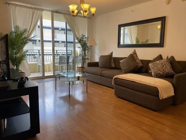 a living room with furniture a lamp and a potted plant