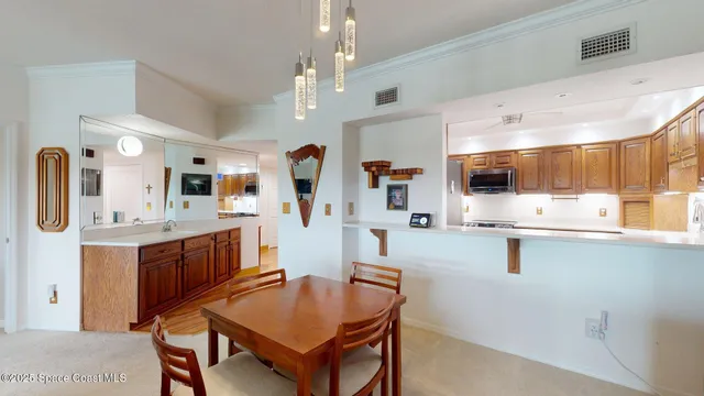 a living room with stainless steel appliances kitchen island granite countertop furniture and a kitchen view