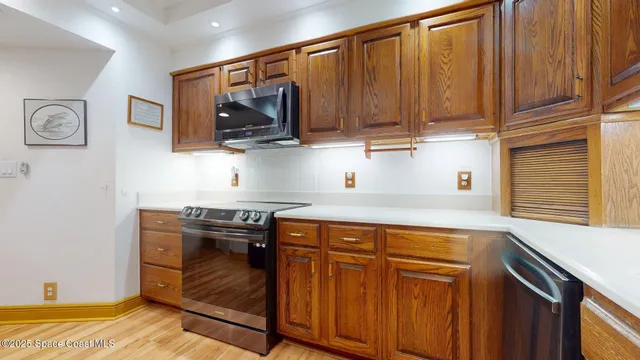a kitchen with stainless steel appliances granite countertop a stove and a microwave