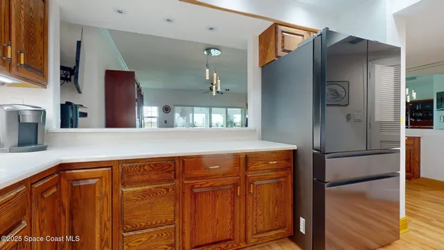 a kitchen with stainless steel appliances granite countertop a refrigerator and a sink