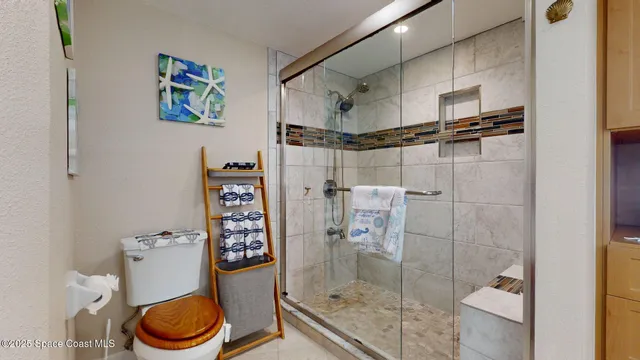 a bathroom with a shower and toilet