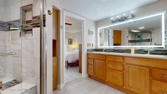 a spacious bathroom with a shower sink and mirror
