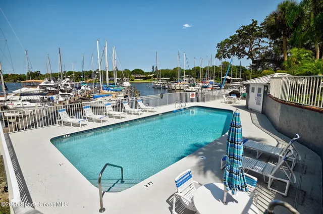 a view of a swimming pool with outdoor seating