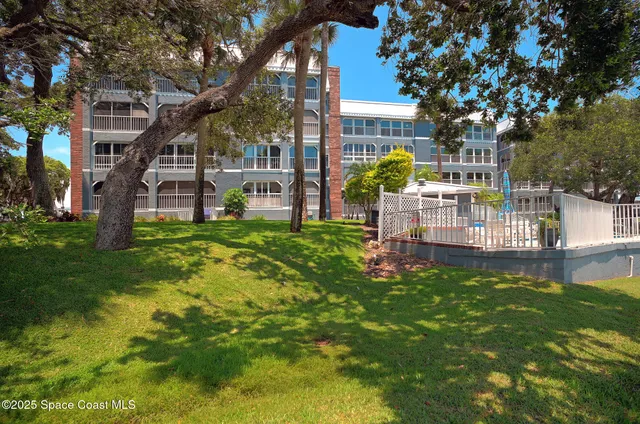 a view of a house with a small yard and sitting area