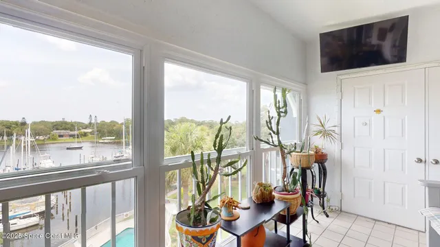 a view of a livingroom with furniture and floor to ceiling windows