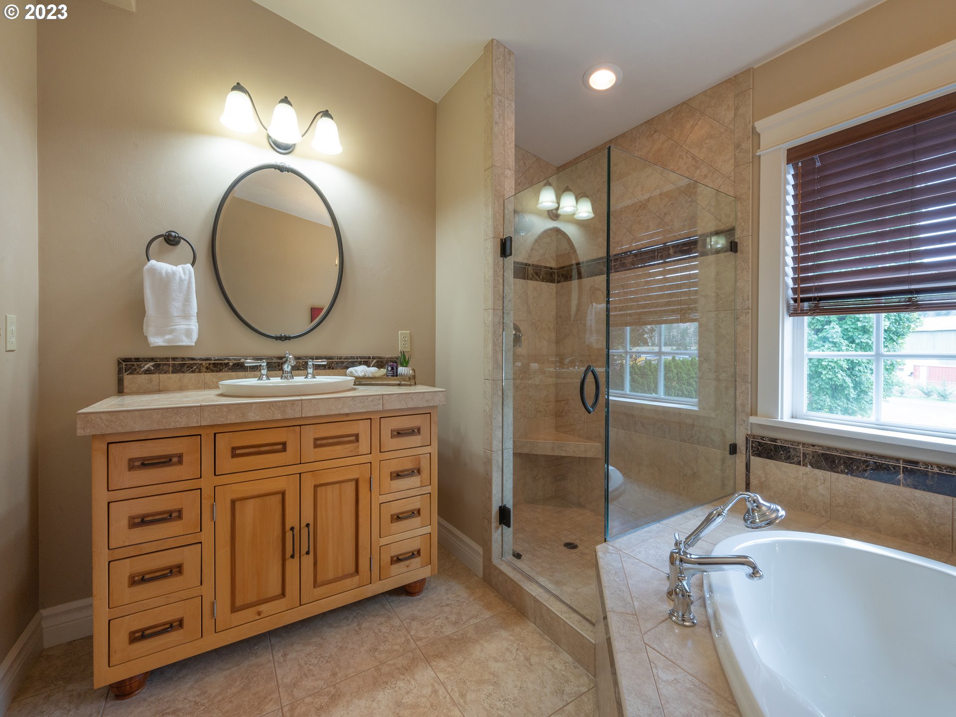 37692 Wheeler Road Dexter, OR 97431 - Photo 31 of 48 a bathroom with a tub a sink double vanity and a mirror