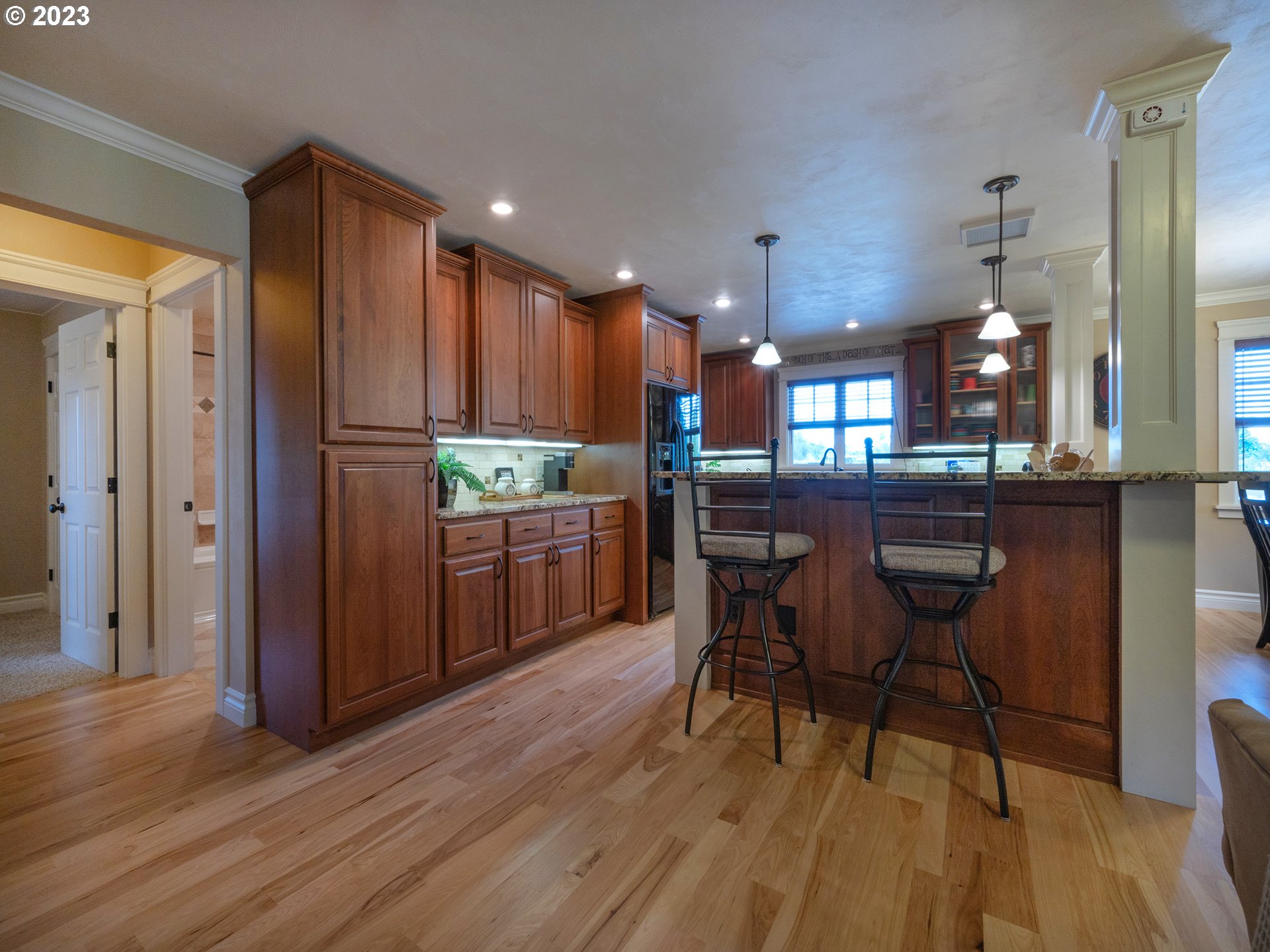 37692 Wheeler Road Dexter, OR 97431 - Photo 7 of 48 a kitchen with stainless steel appliances kitchen island granite countertop wooden floors and wooden cabinets