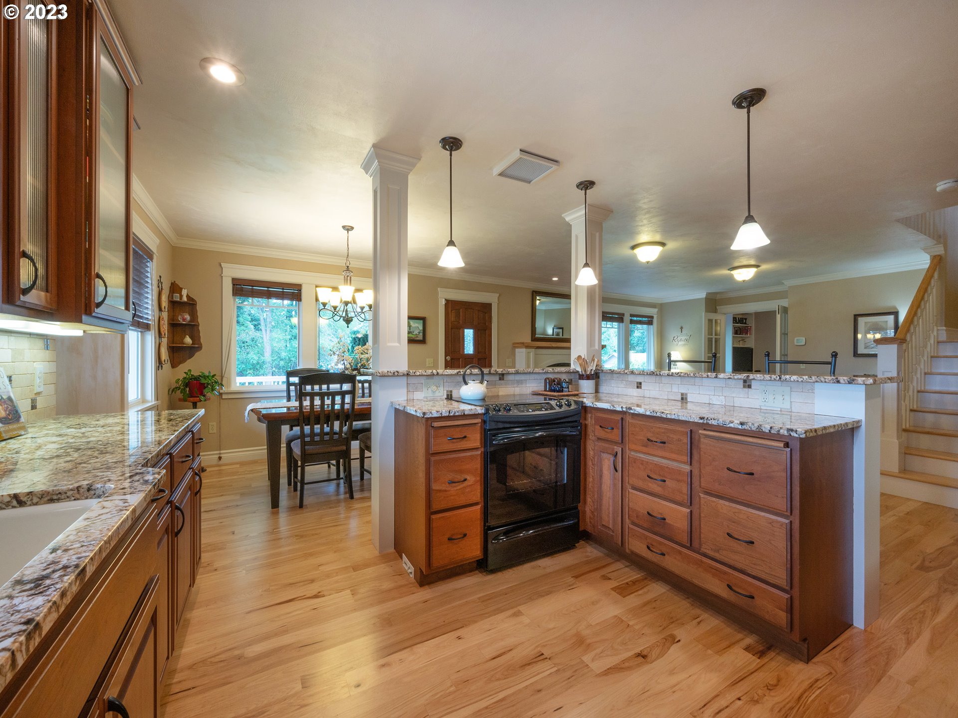 37692 Wheeler Road Dexter, OR 97431 - Photo 9 of 48 a kitchen with granite countertop a stove a sink a dining table and chairs