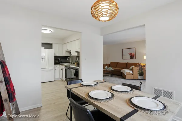 a kitchen with granite countertop white cabinets and stainless steel appliances
