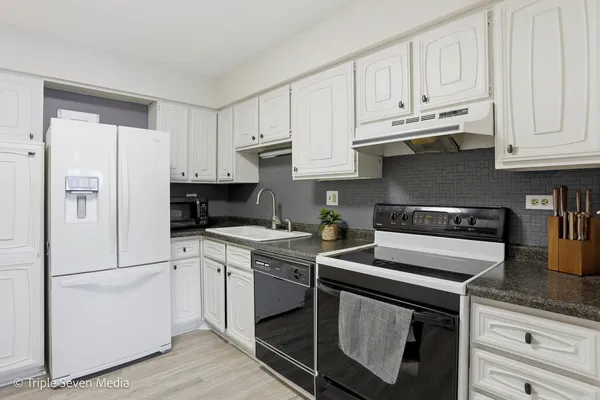 a kitchen with a stove and a refrigerator