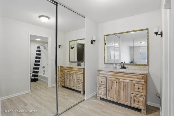 a bathroom with a granite countertop toilet a sink and a bathtub