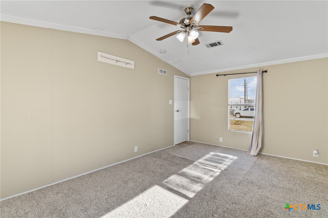 705 Peabody Street Edna, TX 77957 - Photo 13 of 24 a view of a big room with closet and a chandelier fan