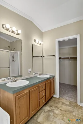 a bathroom with a double vanity sink and a mirror