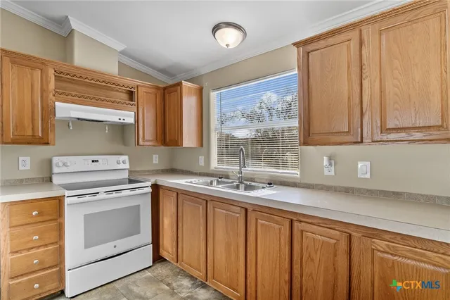 a kitchen with a sink stove and cabinets
