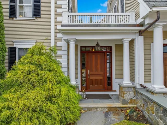 a living room with furniture fireplace and a large window