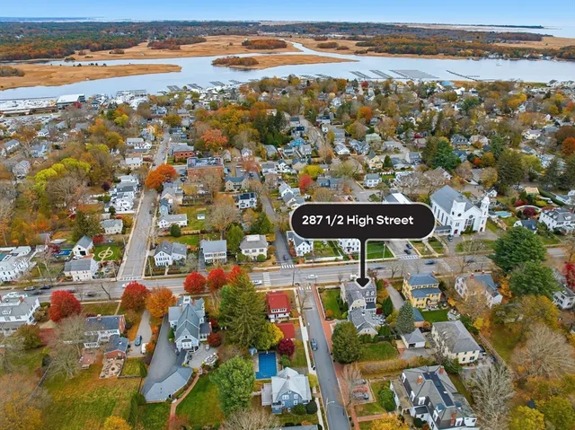a kitchen with stainless steel appliances granite countertop a table chairs and a view of living room