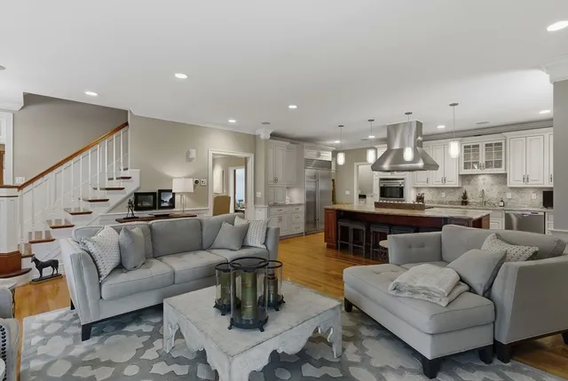 a view of staircase with lots of frames on wall and a chandelier