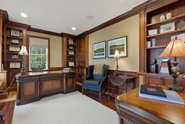 a spacious bathroom with a granite countertop double vanity sink a large mirror and a bathtub