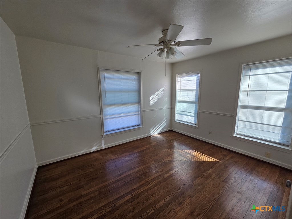 1506 South 9th Street Temple, TX 76504 - Photo 13 of 17 a view of an empty room with wooden floor and window