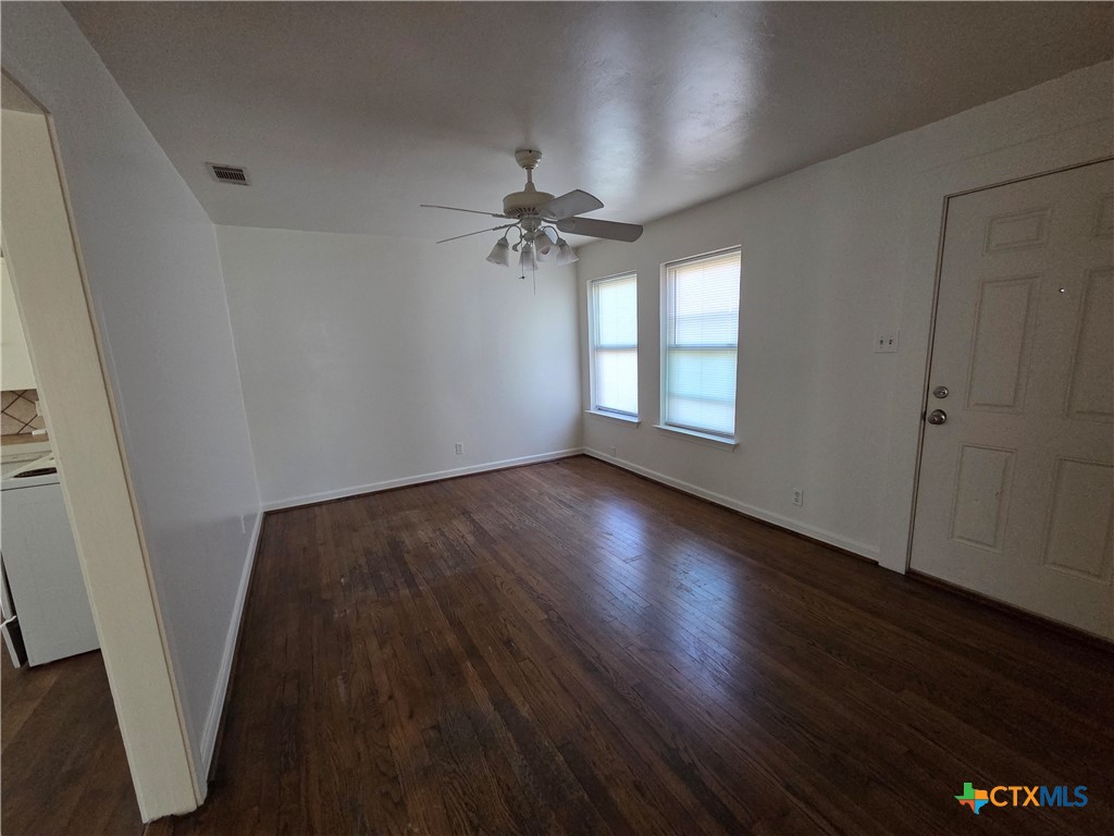 1506 South 9th Street Temple, TX 76504 - Photo 4 of 17 wooden floor in an empty room with a window