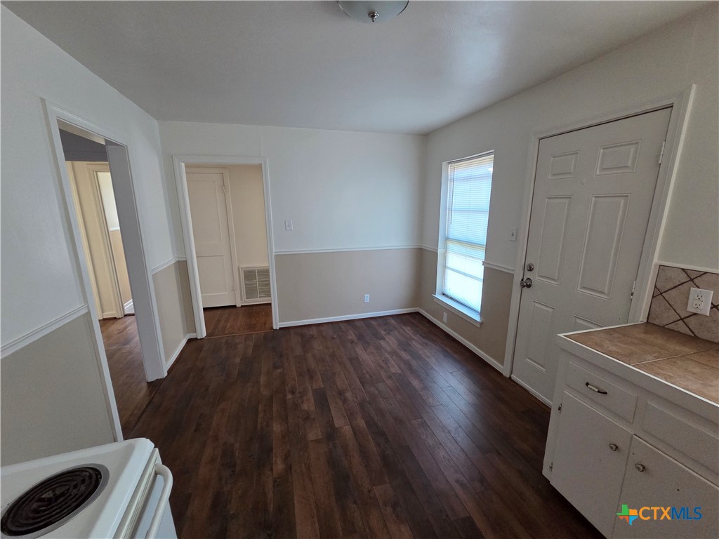 1506 South 9th Street Temple, TX 76504 - Photo 5 of 17 a view of a room with wooden floor and furniture