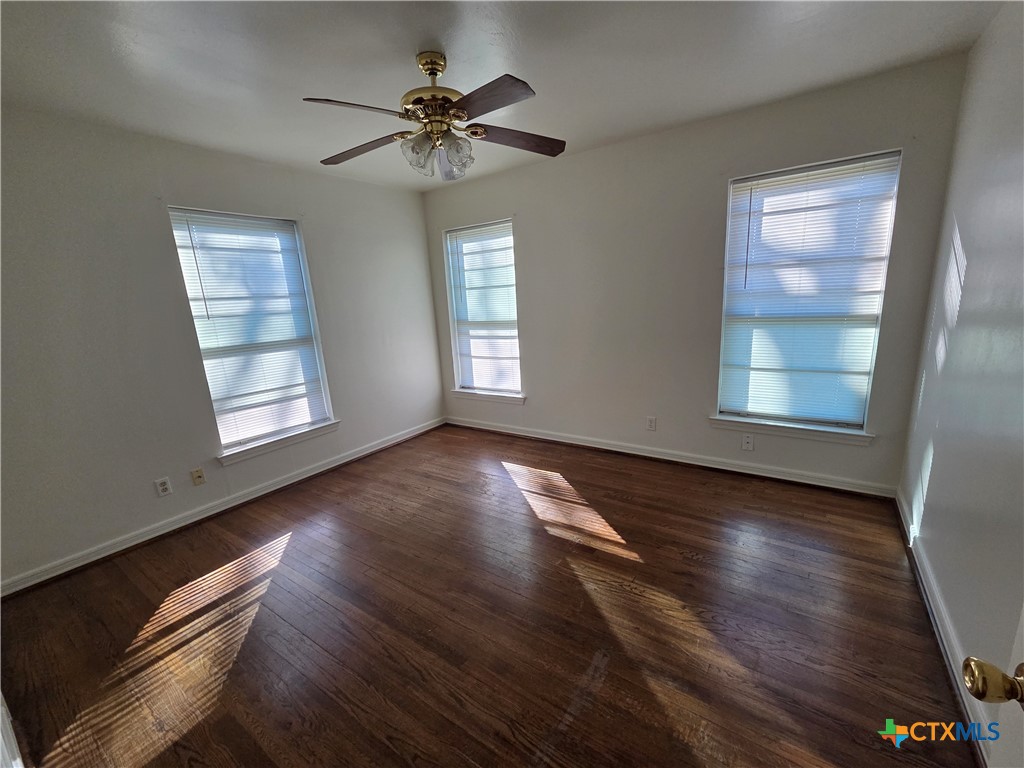 1506 South 9th Street Temple, TX 76504 - Photo 7 of 17 a view of an empty room with wooden floor and a window