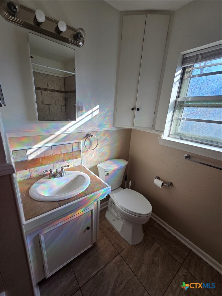 1506 South 9th Street Temple, TX 76504 - Photo 8 of 17 a bathroom with a sink toilet and window