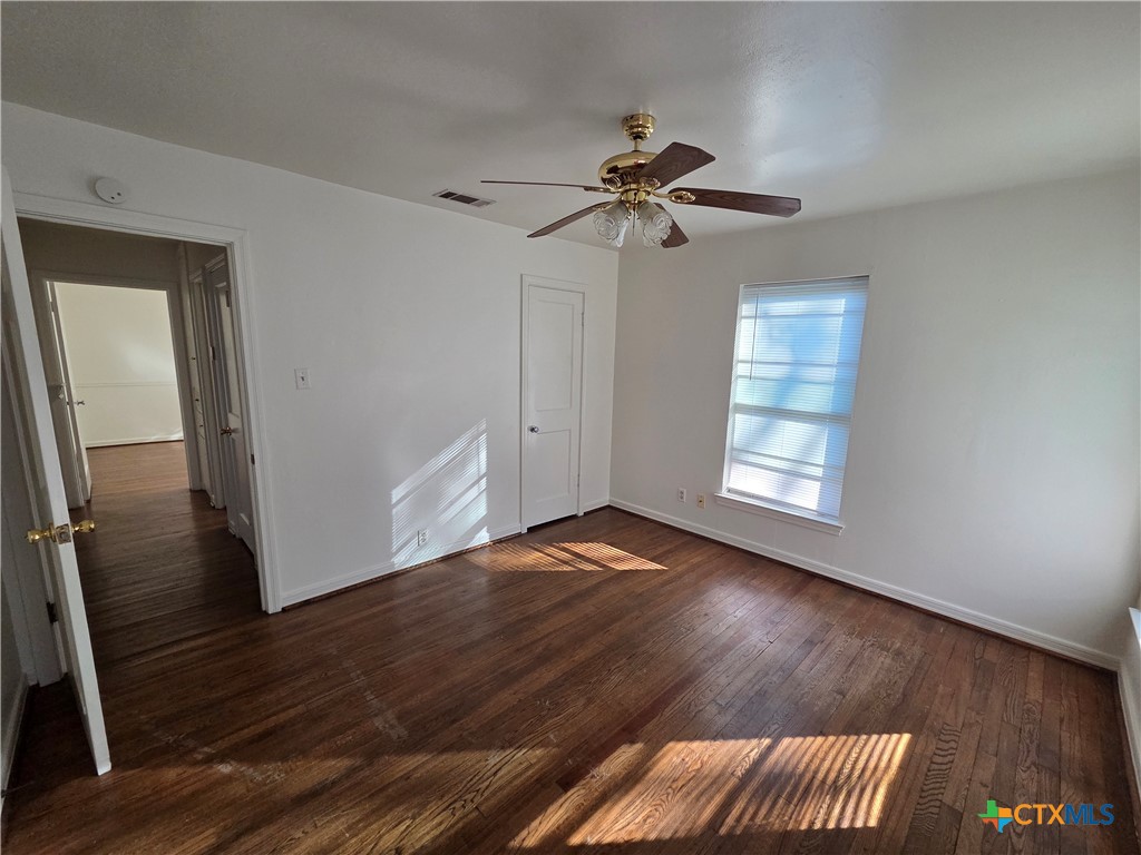 1506 South 9th Street Temple, TX 76504 - Photo 9 of 17 a view of empty room with wooden floor and fan