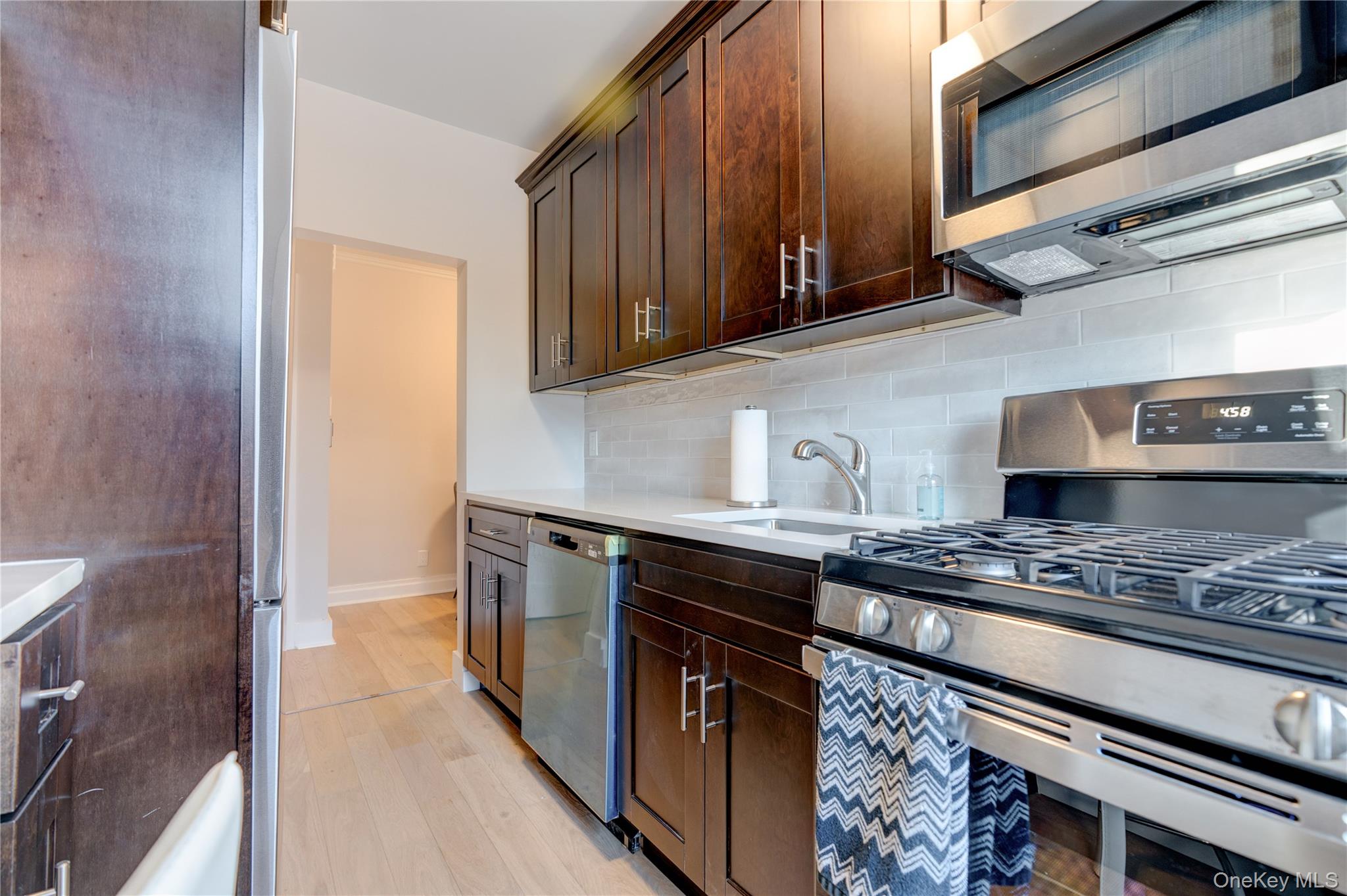 a kitchen with stainless steel appliances granite countertop a stove and a sink
