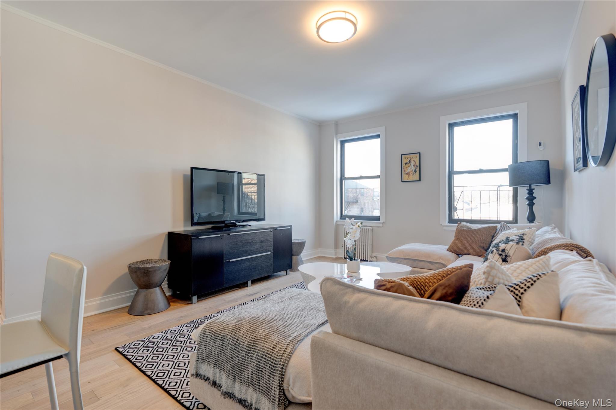 2226 76th Street, Unit C3 Queens, NY 11370 - Photo 12 of 20 a living room with furniture and a flat screen tv