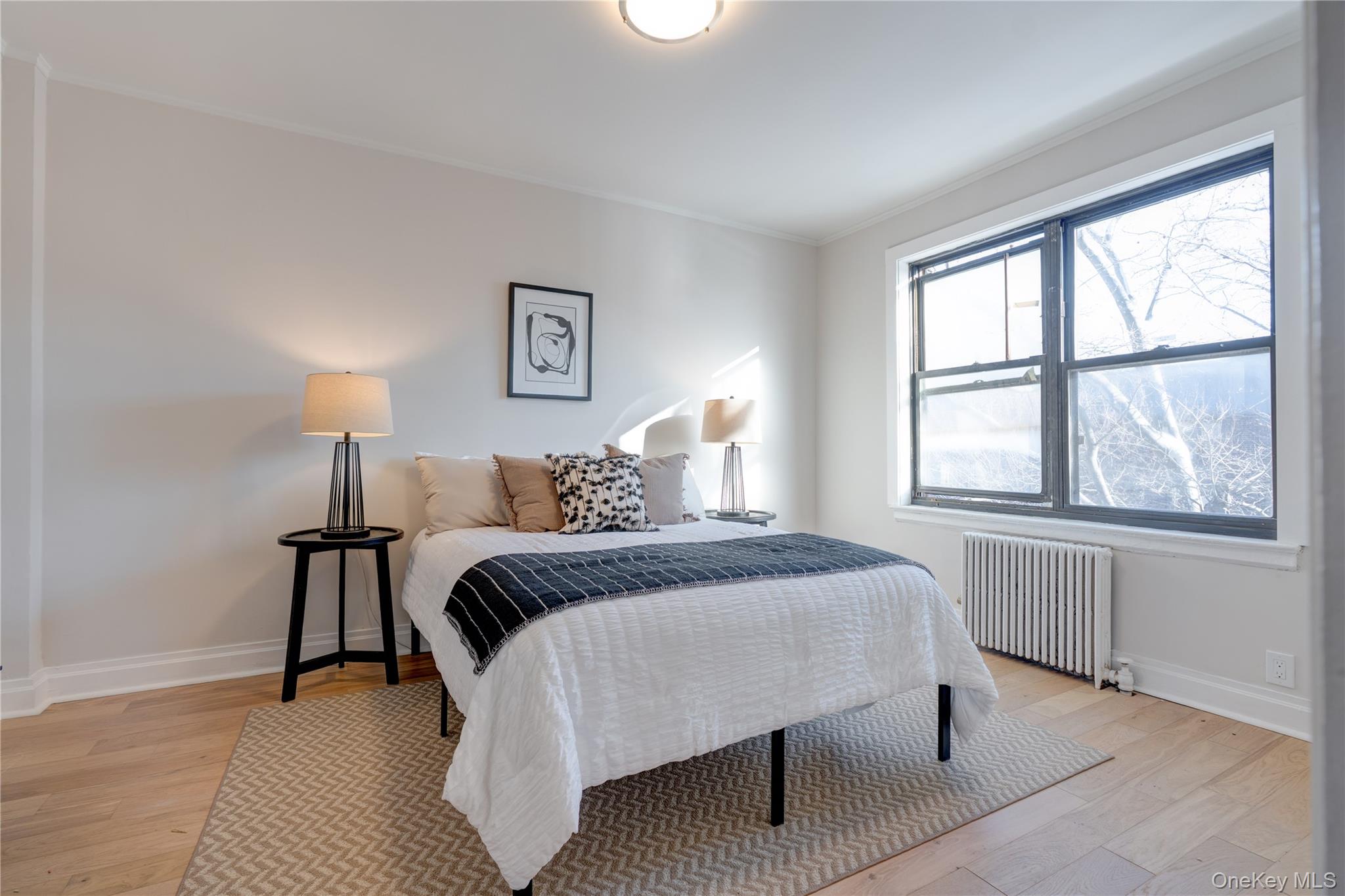 2226 76th Street, Unit C3 Queens, NY 11370 - Photo 15 of 20 a bedroom with a bed and a window