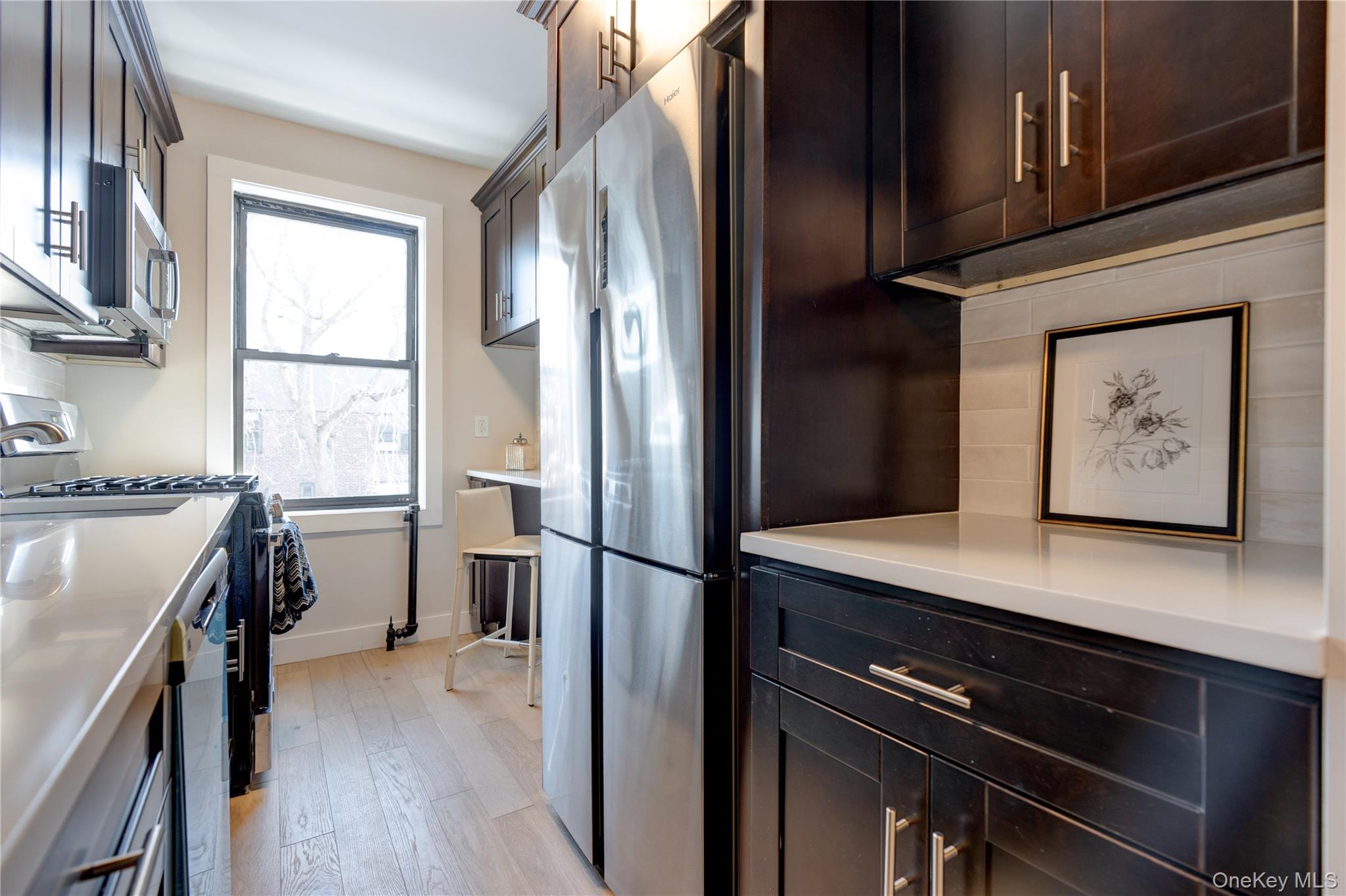2226 76th Street, Unit C3 Queens, NY 11370 - Photo 6 of 20 a kitchen with a refrigerator and a stove top oven