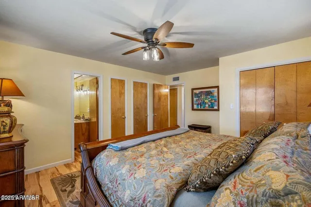 a bedroom with a large bed and a chandelier