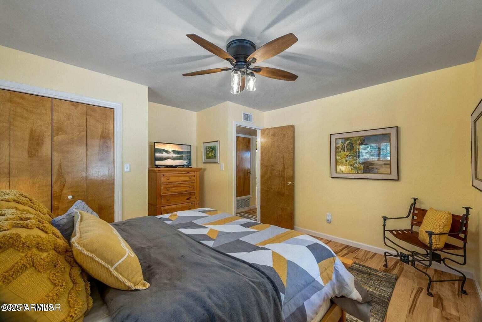 61 County Road 2266 Alpine, AZ 85920 - Photo 25 of 51 a bedroom with a bed and a chandelier